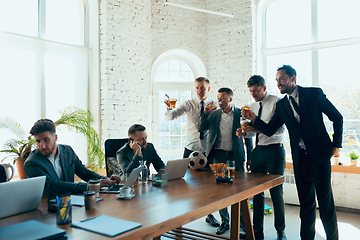 Image showing Happy colleagues having fun in office while their colleagues working hard