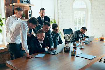 Image showing Happy colleagues having fun in office while their colleagues working hard