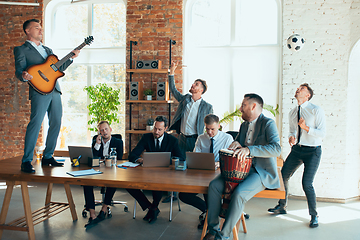 Image showing Happy colleagues having fun in office while their colleagues working hard