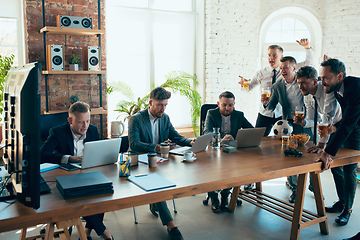 Image showing Happy colleagues having fun in office while their colleagues working hard