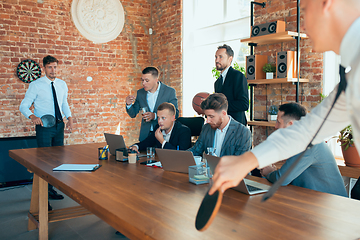 Image showing Happy colleagues having fun in office while their colleagues working hard