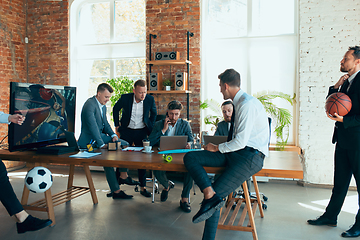 Image showing Happy colleagues having fun in office while their colleagues working hard