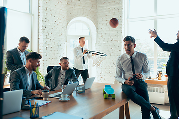 Image showing Happy colleagues having fun in office while their colleagues working hard