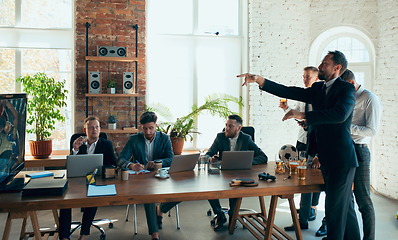 Image showing Happy colleagues having fun in office while their colleagues working hard