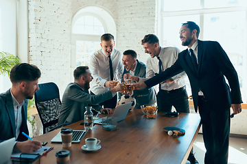 Image showing Happy colleagues having fun in office while their colleagues working hard