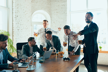 Image showing Happy colleagues having fun in office while their colleagues working hard