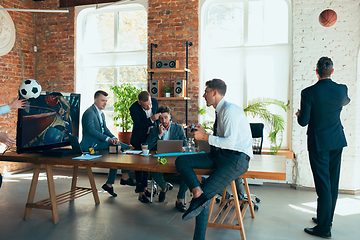 Image showing Happy colleagues having fun in office while their colleagues working hard