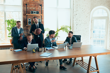 Image showing Happy colleagues having fun in office while their colleagues working hard