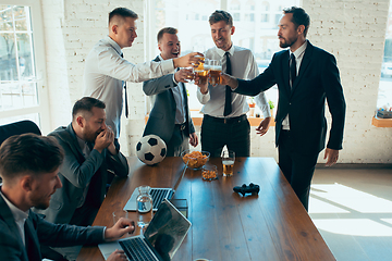 Image showing Happy colleagues having fun in office while their colleagues working hard