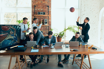 Image showing Happy colleagues having fun in office while their colleagues working hard