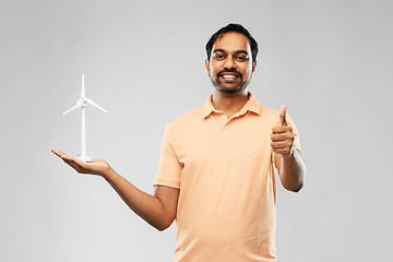 Image showing indian man with toy wind turbine showing thumbs up