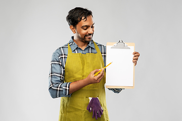 Image showing happy indian gardener or farmer showing clipboard