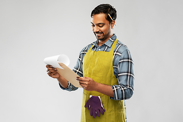 Image showing happy indian gardener or farmer with clipboard