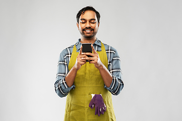 Image showing indian male gardener or farmer with smartphone