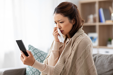 Image showing sick asian woman with smartphone at home