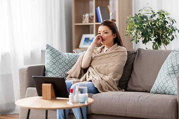 Image showing sick asian woman in blanket at home