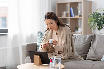 Image showing sick woman with medicine has video consultation