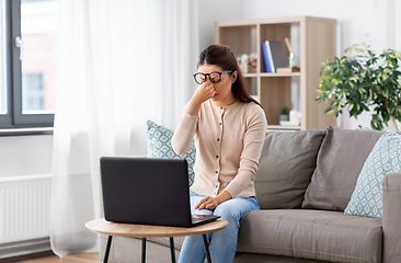 Image showing tired woman with laptop working at home office