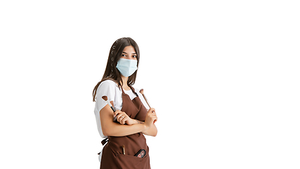 Image showing Young woman, visagiste with cosmetics isolated on white studio background