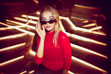 Image showing Cinematic portrait of handsome young woman in neon lighted room, stylish musician