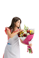 Image showing Young woman, florist with bouquet isolated on white studio background