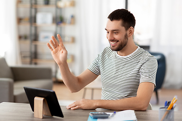 Image showing man with tablet pc having video call at home