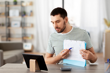 Image showing man with tablet pc having video call at home