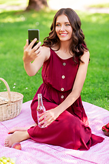 Image showing happy woman with smartphone taking selfie at park