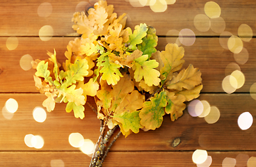 Image showing oak leaves in autumn colors on wooden table