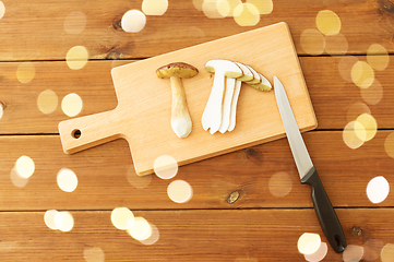 Image showing edible mushrooms, kitchen knife and cutting board