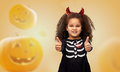 Image showing girl in black dress and devil's horns on halloween