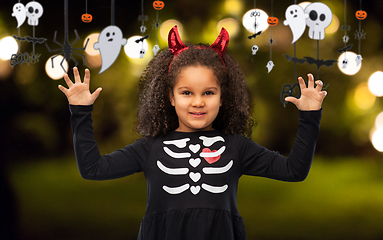 Image showing girl in black dress and devil's horns on halloween