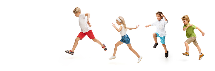 Image showing Happy little caucasian kids jumping and running isolated on white background