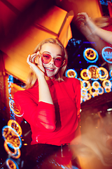 Image showing Cinematic portrait of handsome young woman in neon lighted room, stylish musician