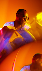 Image showing Cinematic portrait of handsome young man in neon lighted room, stylish musician