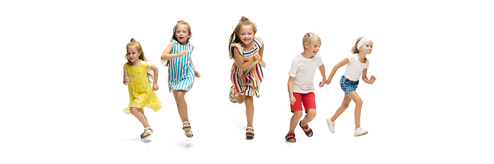 Image showing Happy little caucasian kids jumping and running isolated on white background