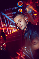 Image showing Cinematic portrait of handsome young man in neon lighted room, stylish musician