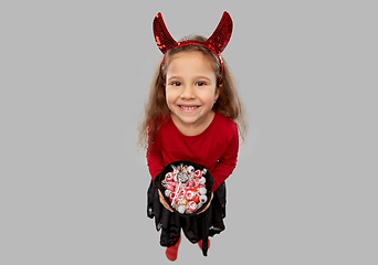 Image showing girl with horns trick-or-treating on halloween