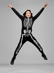 Image showing happy boy in halloween costume of skeleton jumping