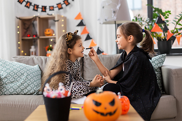 Image showing girls doing face painting on halloween at home