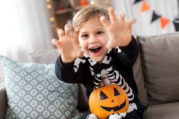 Image showing happy boy in halloween costume of skeleton at home