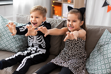 Image showing kids in halloween costumes having fun at home