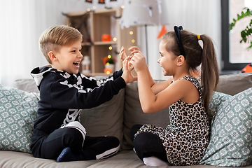 Image showing kids in halloween costumes having fun at home