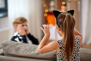 Image showing kids in halloween costumes having fun at home