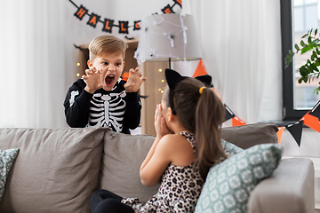 Image showing kids in halloween costumes playing at home