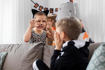 Image showing kids in halloween costumes playing at home