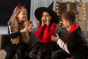 Image showing kids in halloween costumes playing at home