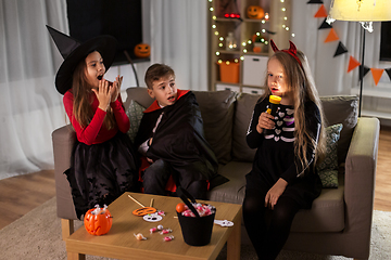 Image showing kids in halloween costumes playing at home