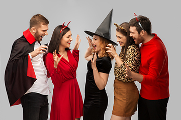 Image showing friends in halloween costumes scaring each other