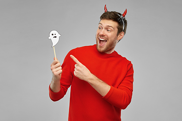 Image showing happy man in halloween costume of devil over grey